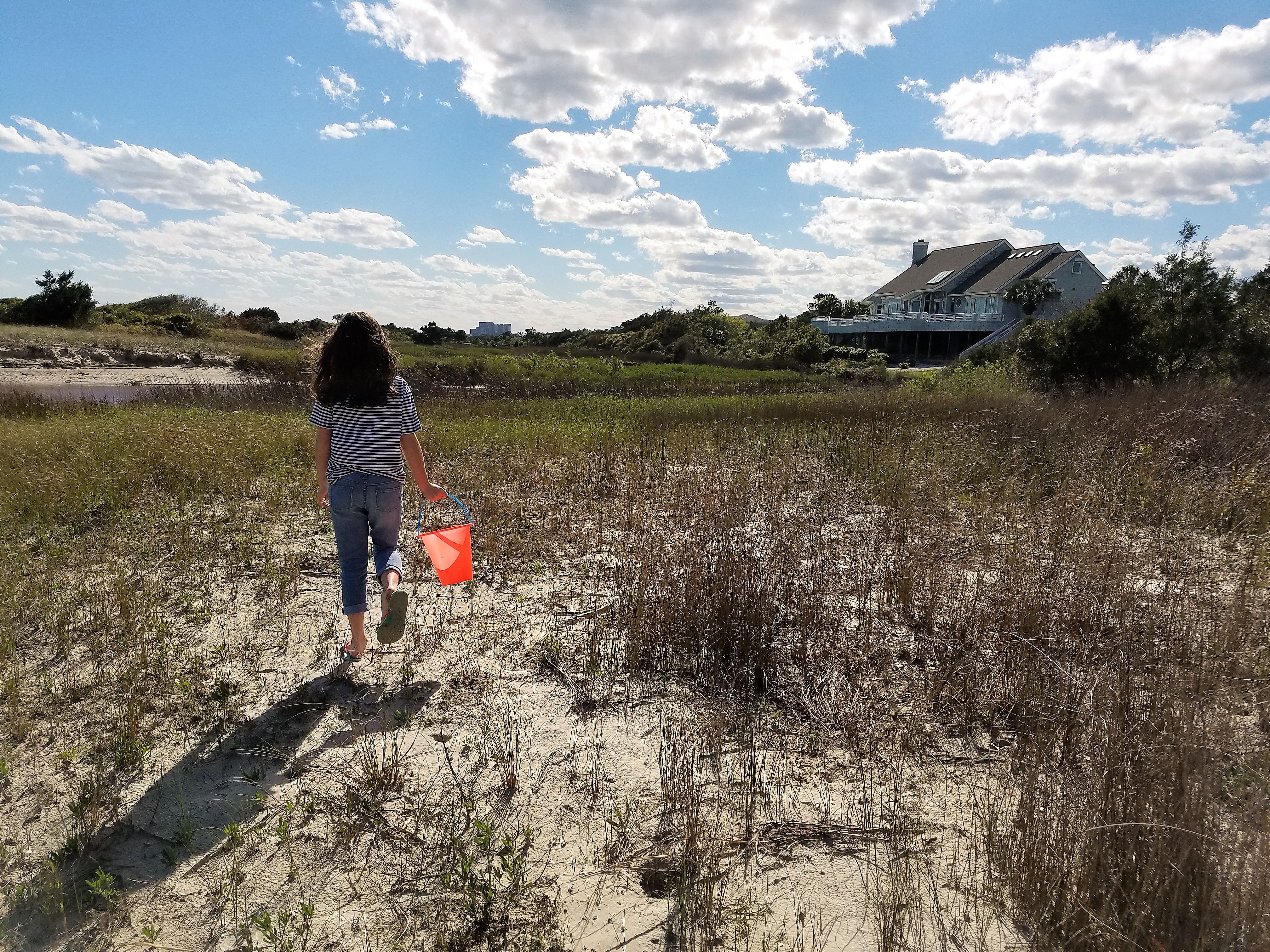 Girl walking with sand bucket in Myrtle Beach