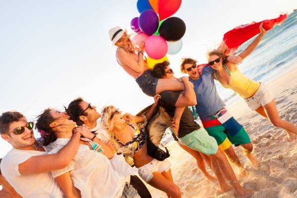 Students on celebrating graduation on the beach