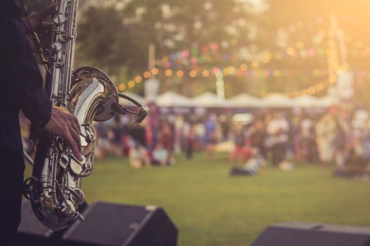 Jazz musician playing outdoor concert.