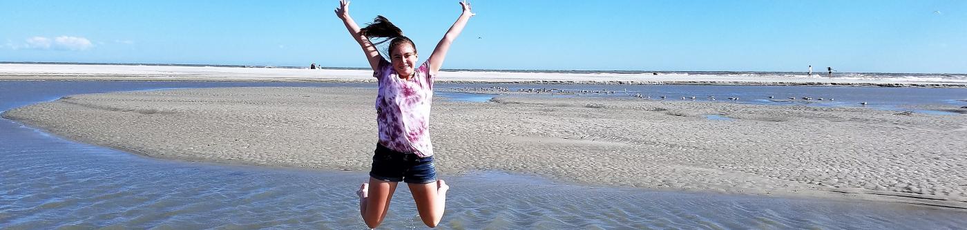 Girl jumping in excitement on Myrtle Beach