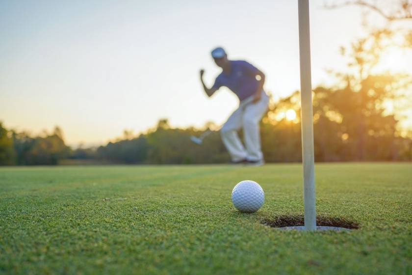 Celebrating a hole in one at a golf course.
